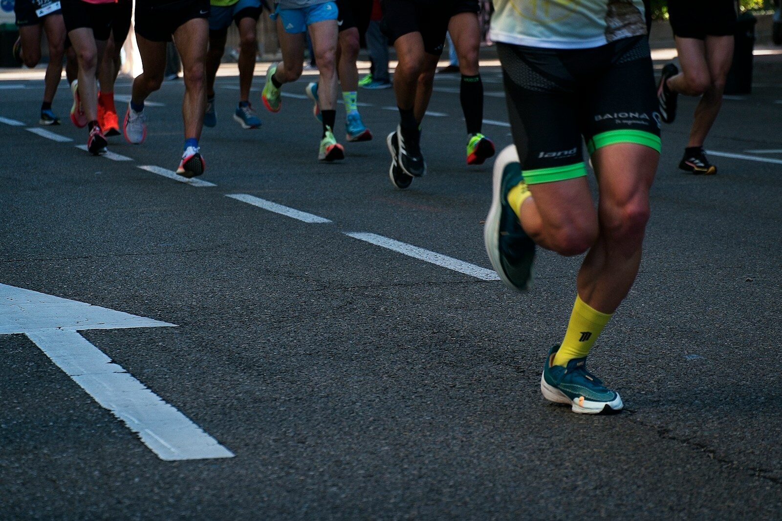 a group of people running down a street
